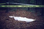 Dead body covered with sheet on murder crime scene